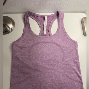 Purple lululemon swiftly tech tank top in race length, size 4.